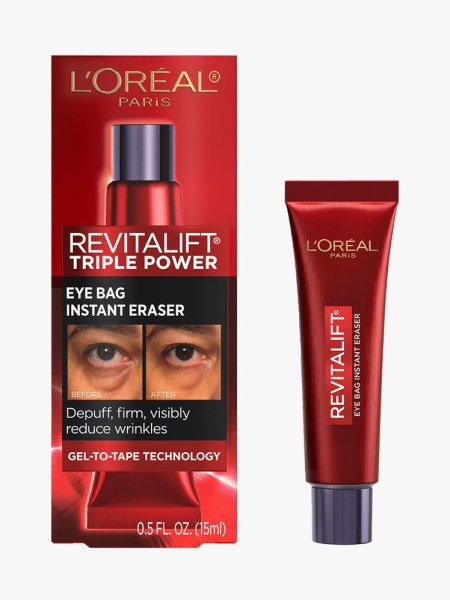 Red tube of L’Oréal Paris Revitalift Triple Power Eye Bag Instant Eraser with black cap on light gray background